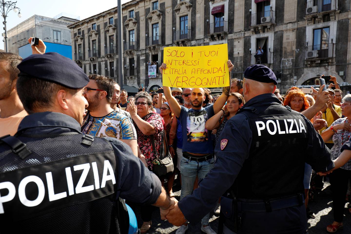 REFILE - ADDING TRANSLATION People protest against Italian Interior Minister and leader of the League party Matteo Salvini in Catania, Italy, August 11, 2019. The banner reads "Just your interests and Italy sinks! Shame on you." REUTERS/Antonio Parrinello