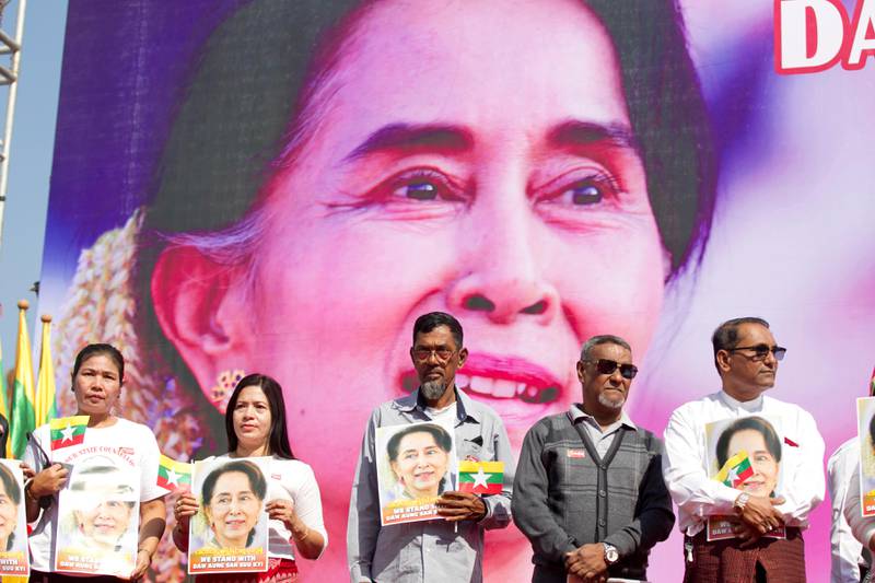 FILE - In this Tuesday, Dec. 10, 2019 file photo, Members of Myanmar Muslims community hold portraits of Myanmar leader Aung San Suu Kyi to pray as they gather in front of City Hall in Yangon, Myanmar. The U.N. General Assembly approved a resolution Friday, Dec. 27, 2019 strongly condemning human rights abuses against Myanmars Rohingya Muslims and other minorities, including arbitrary arrests, torture, rape and deaths in detention. (AP Photo/Thein Zaw, File)