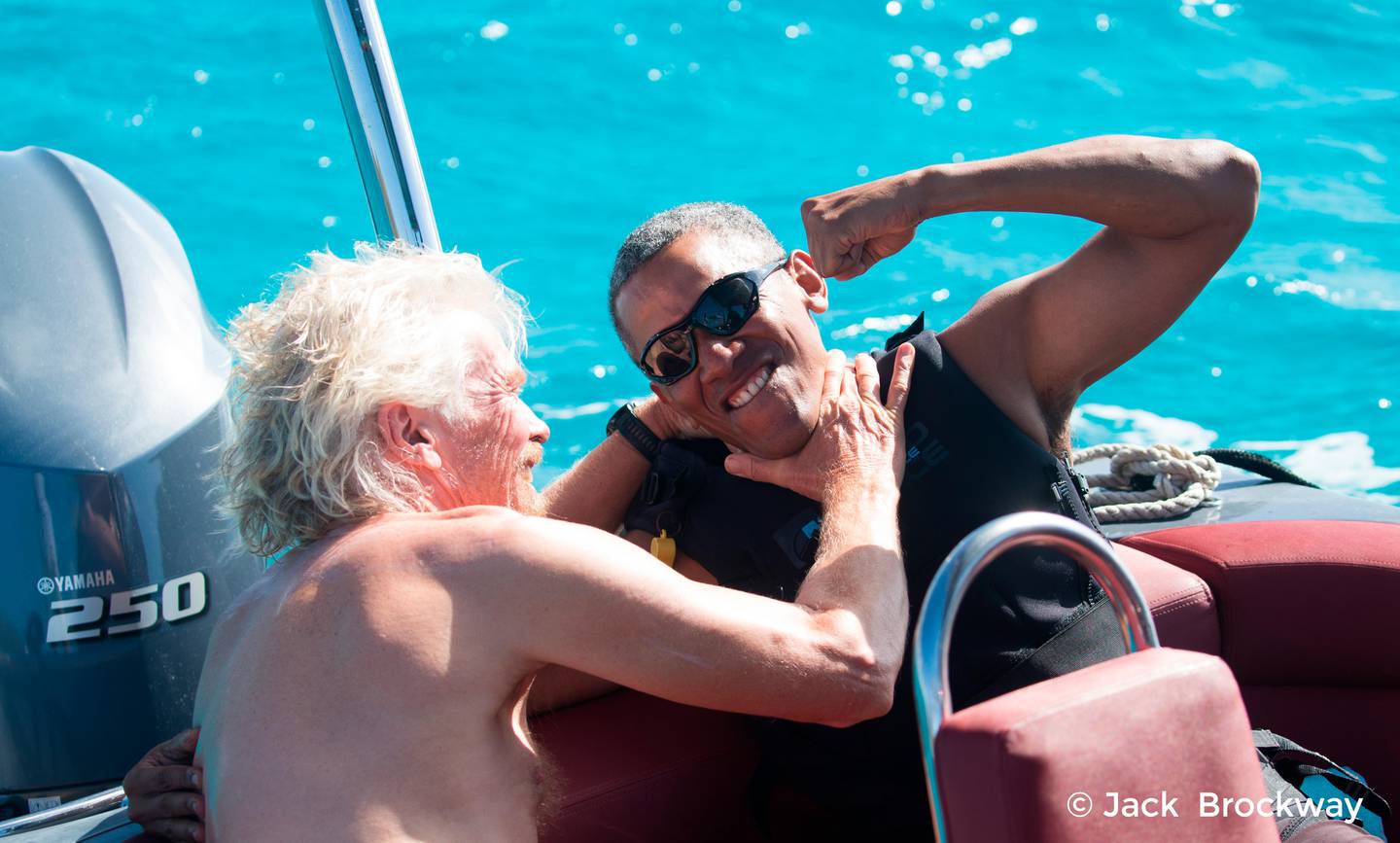 In this recent but undated photo made available by Virgin.com, former U.S President Barack Obama, jokes with Richard Branson, founder of the Virgin Group, during his stay on Moskito Island, British Virgin Islands. The former president and his wife stayed on Mosikto Island owned by Richard Branson, founder of the Virgin Group, after he finished his second term as President and left the White House. (Jack Brockway/Virgin.com via AP)