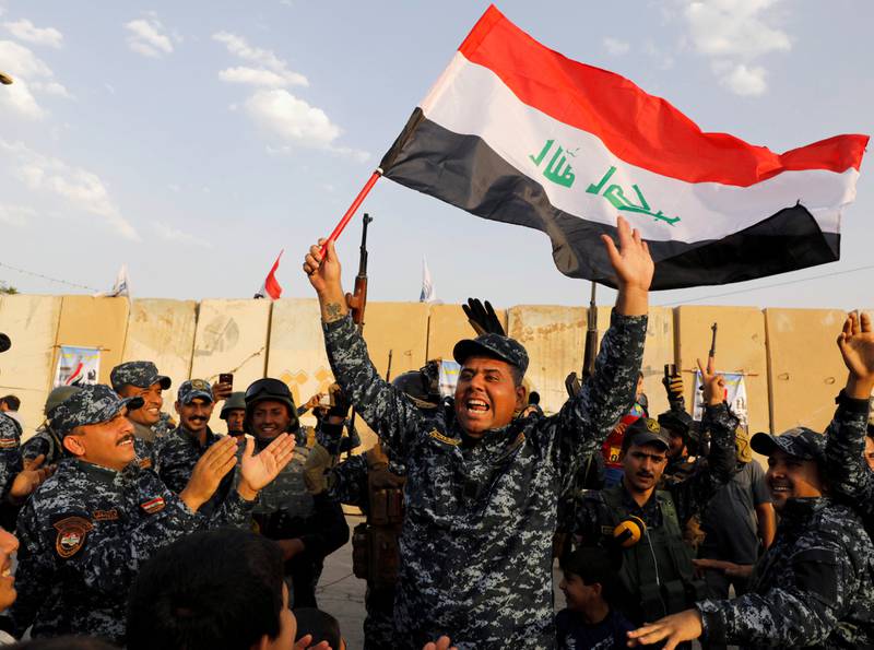 Iraks statsminister Haider al-Abadi erklærte lørdag at kampen mot IS er over. På dette bildet feirer irakiske politimenn en vellykket militæroperasjon mot IS i juli.