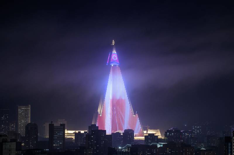 TOPSHOT - A light show is displayed on the Ryugyong hotel (C) amid the city skyline, seen from the Yanggakdo hotel in Pyongyang on September 5, 2018. - North Korea is preparing to mark the 70th anniversary of its founding. (Photo by Ed JONES / AFP)