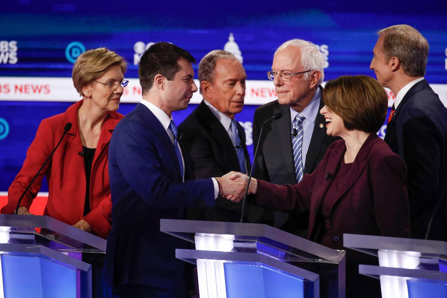 From left, Democratic presidential candidates, Sen. Elizabeth Warren, D-Mass., former South Bend Mayor Pete Buttigieg, former New York City Mayor Mike Bloomberg, Sen. Bernie Sanders, I-Vt., Sen. Amy Klobuchar, D-Minn., and businessman Tom Steyer, greet on another on stage at the end of the Democratic presidential primary debate at the Gaillard Center, Tuesday, Feb. 25, 2020, in Charleston, S.C., co-hosted by CBS News and the Congressional Black Caucus Institute. (AP Photo/Patrick Semansky)