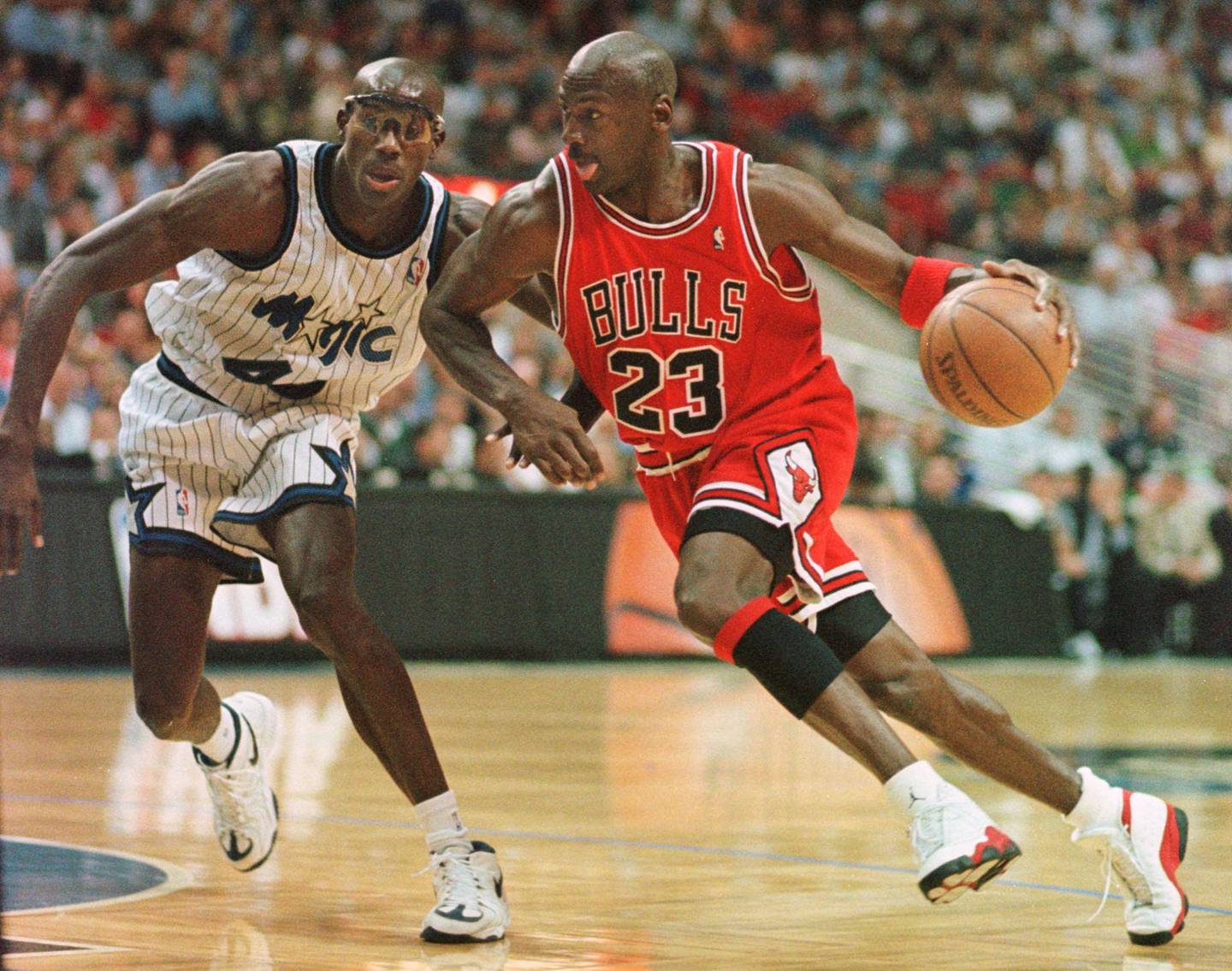 
Chicago Bulls guard Michael Jordan drives past Orlando Magic forward Charles Outlaw for two points during the first period of the game at the Arena in Orlando, 25 March. AFP PHOTO TONY RANZE