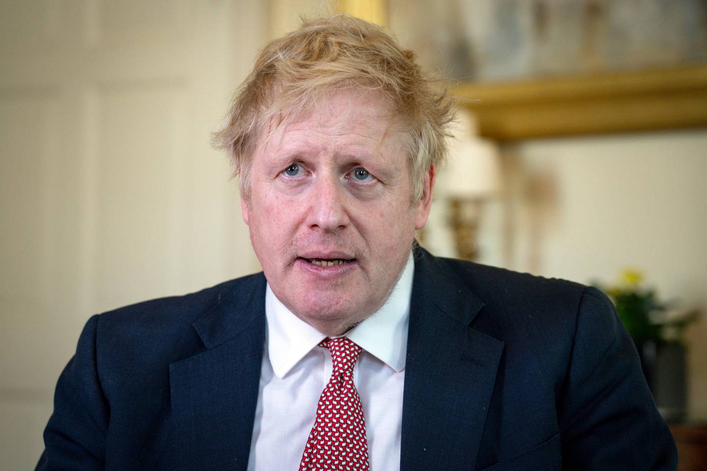 In this handout photo issued by 10 Downing Street, Britain's Prime Minister Boris Johnson speaks from 10 Downing Street praising NHS staff in a video message, after he was discharged from hospital a week after being admitted with persistent coronavirus symptoms, in London, Sunday, April 12, 2020. British Prime Minister Boris Johnson is praising the National Health Service staff for saving his life in a video on Twitter after his discharge from St. Thomas Hospital in London. He said he did not have the words to properly thank the staff at NHS for saving my life. He lauded two nurses Johnson said stood by his bedside for 48 hours when things could have gone either way. (Pippa Fowles/10 Downing Street via AP)