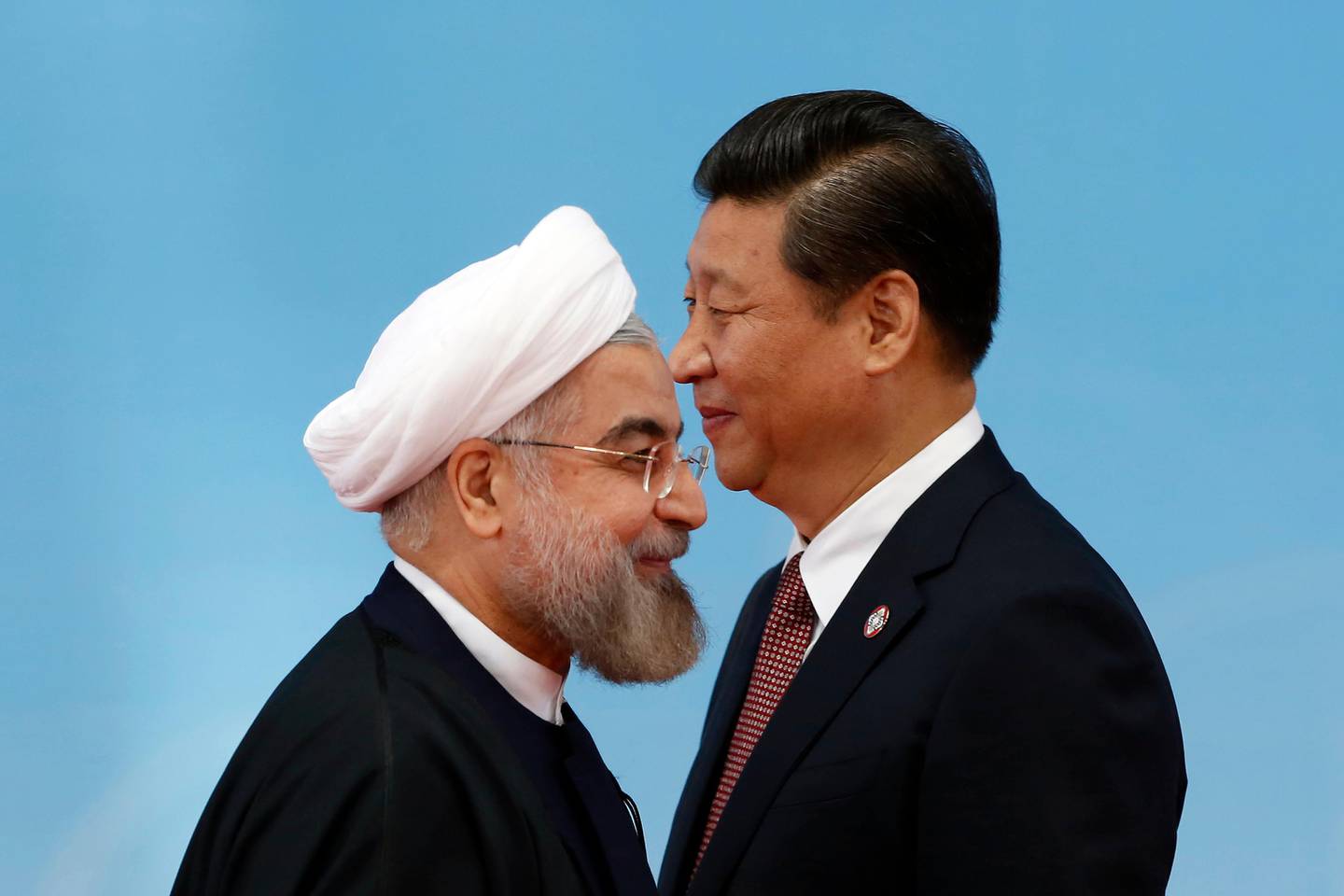 Iran's President Hassan Rouhani, left, walks away after shaking hands with Chinese President Xi Jinping before the opening ceremony at the fourth Conference on Interaction and Confidence Building Measures in Asia (CICA) summit in Shanghai, China Wednesday, May 21, 2014. (AP Photo/Aly Song, Pool)
